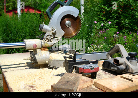 Circular saw and other tools on the background of nature in summer Stock Photo