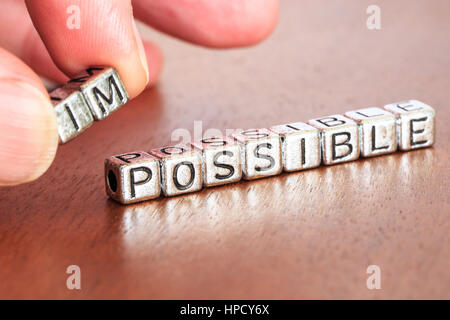 impossible possible business letters placed on a desk in precious wood Stock Photo