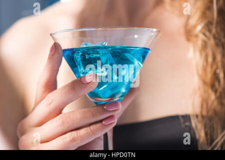 partial close up view of woman holding in hand cocktail drink Stock Photo