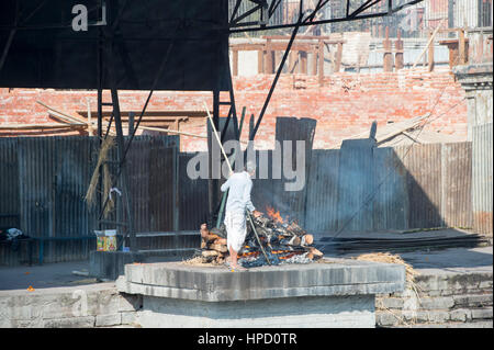 A cremation ceremony on one of the Ghats at this site of the Holy Temple of Lord Shiva at Pasupatinath Temple in Kathmandu, Nepal. Stock Photo