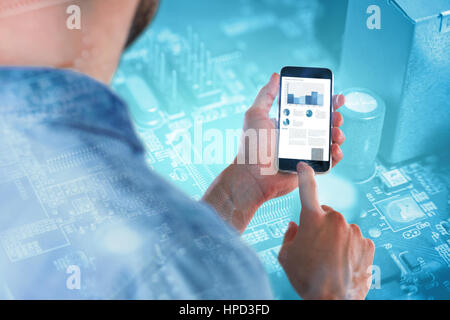Man using mobile phone against micro parts in mother board Stock Photo