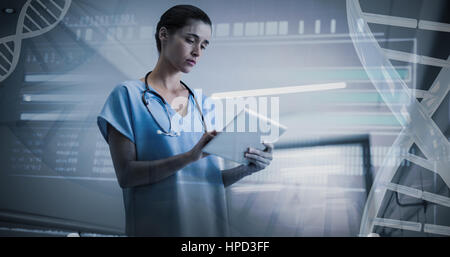 Genetic research information on DNA against serious female surgeon using digital tablet Stock Photo