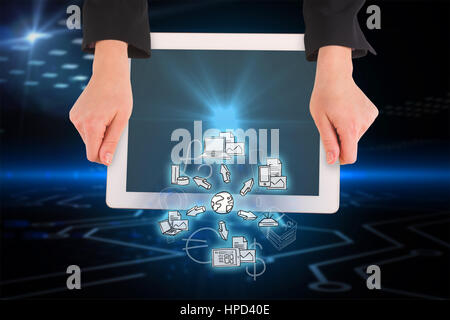 Feminine hands holding tablet against circuit board on futuristic background Stock Photo