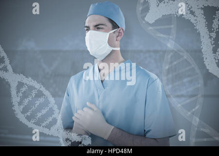 Surgeon wearing medical gloves and mask against panoramic view of dna pattern on screen Stock Photo