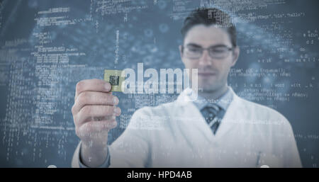 Engineer holding computer chip against blue printed circuit board Stock Photo