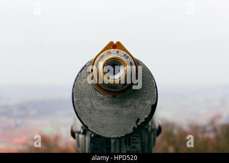 Coin operated binoculars on the viewing platform at Petrin Observation Tower, Prague, Czech Republic with the blurred city background. Stock Photo