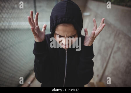Close-up of angry teenage girl standing at school campus Stock Photo