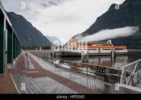 One of the many scenic cruising boats that abound in Milford Sound, South Island, New Zealand. Stock Photo