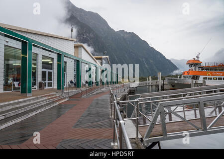 Milford Sound fresh water basin a cruise terminal and one of the many scenic cruising boats that abound in Milford Sound, South Island, New Zealand. Stock Photo