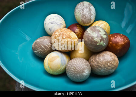 Still life photo of easter eggs in a turquoise bowl. Stock Photo