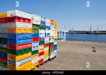NEXOE, DENMARK - JULY 13, 2013: colourful fish crates of plastic, standing stacked on the harbor of Nexo, Bornholm Stock Photo