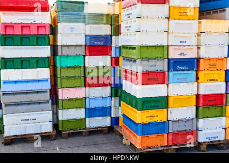 NEXO, DENMARK - JULY 13, 2013: colourful plastic fish boxes piled up in tall stacks on the harbour of Nexoe on Bornholm Stock Photo
