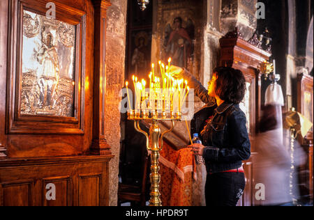 Kapnikarea church, byzantine style, woman doing an offering, Athens, Greece, Europe Stock Photo