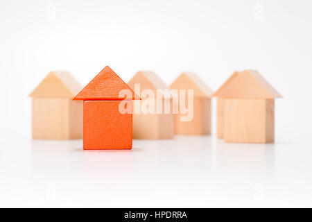 Unique red house made out of toy blocks among wooden blocks. Stock Photo