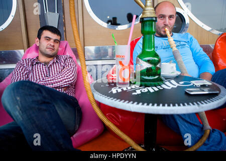 Friends in Maxigala, cafe terrace under Galata Bridge, Yeni Galata Koprusu EH 10, Eminonu, Turkey, Istanbul, Stock Photo