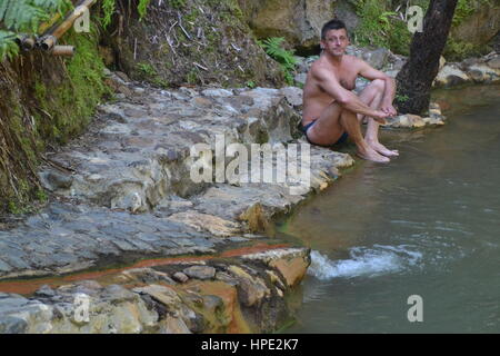 Thermal water and hot springs in Caldeira Velha is located in forest in center of Sao Miguel island on Azores, Portugal, near Ribeira Grande city. Stock Photo