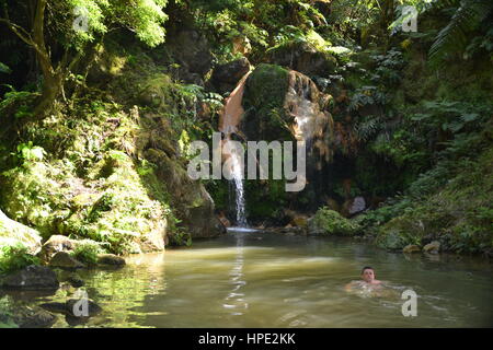 Thermal water and hot springs in Caldeira Velha is located in forest in center of Sao Miguel island on Azores, Portugal, near Ribeira Grande city. Stock Photo