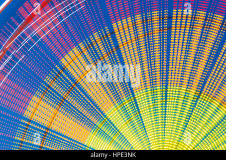 Motion Blurred Effect Around Of High Speed Rotating Illuminated Attraction Feature In City Amusement Park. Ferris Wheel Abstract Background. Stock Photo