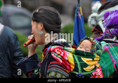 SA PA - FEBRUARY 23, 2013: An unidentified Hmong woman carrying her child in her baby carrier in Northern Vietnam. The Hmong's are one of the largest  Stock Photo