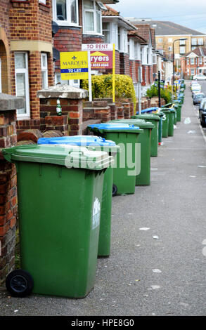 a row of green wheelie bins ready for rubbish collection in cornwall ...