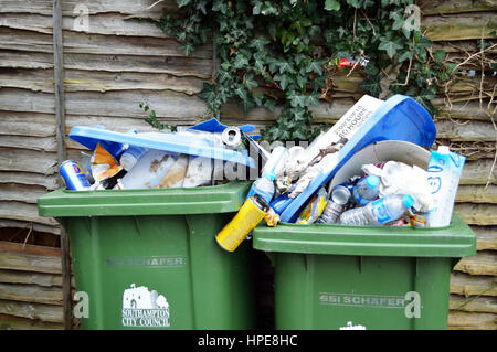 Two overflowing green rubbish bins Stock Photo