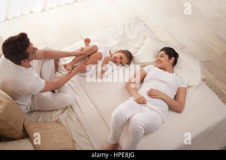 Mother watching daughter playing with her father Stock Photo