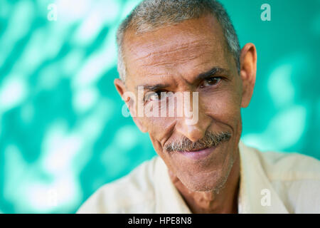 Real Cuban elderly people and feelings, portrait of happy old hispanic man with mustache from Havana, Cuba looking at camera and smiling Stock Photo