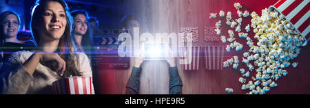 Man watching movies streaming online using a digital tablet, popcorn, 3D glasses and clapboard, cinema and entertainment concept Stock Photo