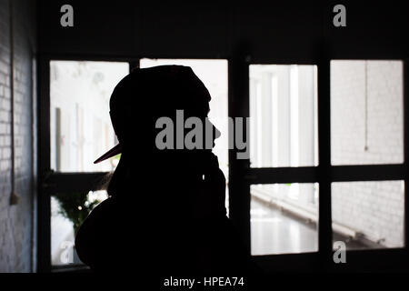 Silhouette of person in profile in a building. Stock Photo