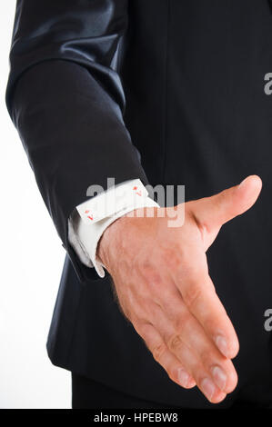 Frontal view of the hand of a man dressed in a suit with an ACE up the sleeve isolated on white. Stock Photo