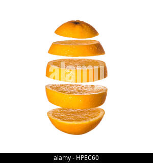 Flying orange. Sliced orange isolated on white background. Levity fruit floating in the air. Stock Photo