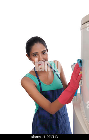 Close-up of young woman cleaning refrigerator Stock Photo