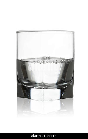 Water in a glass with its reflection isolated on white background Stock Photo