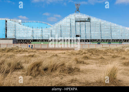 Norfolk coast UK, a view across the sand dunes towards the rear of the roller-coaster ride at Great Yarmouth, UK. Stock Photo