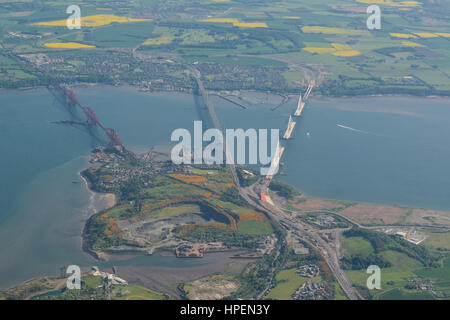 Aerial view of Queensferry Crossing during construction, and the Forth Road Bridge and Forth Bridge, crossing the Firth of Forth, Edinburgh, Scotland Stock Photo