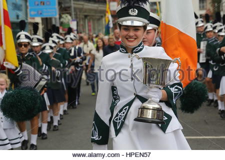 A young woman carries a trophy at the head of the parade to end the Fleadh Cheoil Irish music festival in Sligo Stock Photo