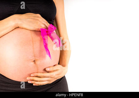 Mom holds pink ribbon on her belly Stock Photo