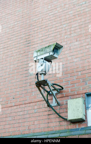 Large old cctv camera mounted on a brick wall in Brindley Place, Birmingham Stock Photo