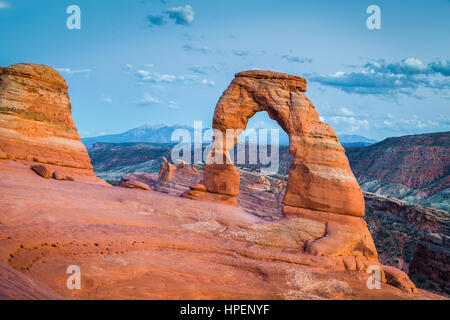 Classic postcard view of famous Delicate Arch, symbol of Utah and a popular scenic tourist attraction, in beautiful post sunset twilight at dusk, USA Stock Photo