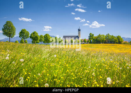 Classic view of famous Wilparting Pilgrimage Church with green meadows on a scenic sunny day with blue sky and clouds in springtime, Bavaria, Germany Stock Photo