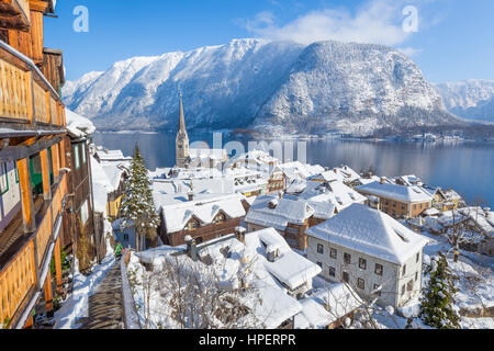 Classic aerial postcard view of famous Hallstatt lakeside town in the Alps on a beautiful cold sunny day with blue sky and clouds in winter, Austria Stock Photo