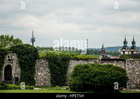 Green park with wall with skyline Church and radio tower in Krakow Poland Stock Photo