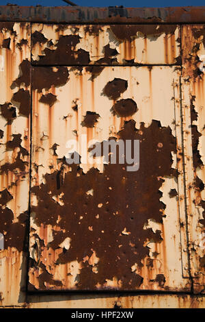 Rusted door on yellow cab of old excavator machine. Stock Photo