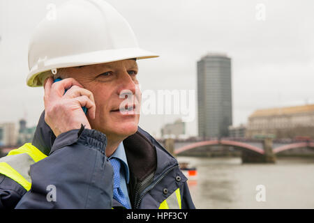 Civil engineer talking on cell phone. Stock Photo