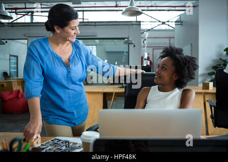 Female graphic designers having a conversation in creative office Stock Photo