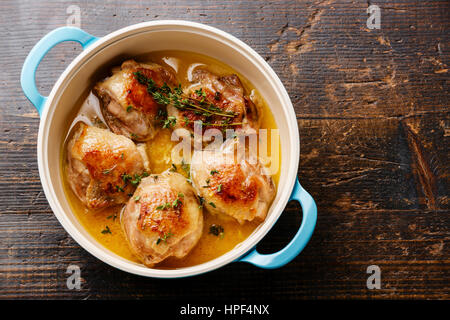 Roast chicken stew in cast iron pan on wooden background copy space Stock Photo