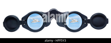 The sky with bird reflected in a pair of binoculars. Tourist binoculars isolated on a white background. Binoculars and blue sky, concept of searching  Stock Photo