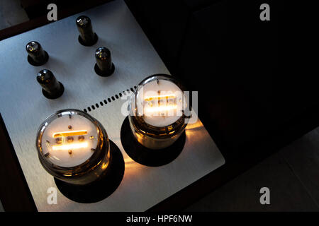 Vintage retro music amplifier with glass lamps light on Stock Photo