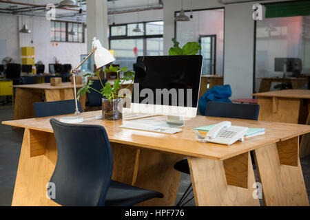 Personal computer and landline on desk in creative office Stock Photo