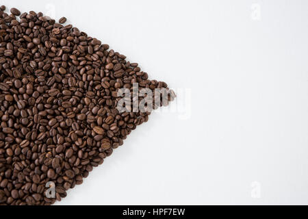 Coffee beans forming shape on white background Stock Photo